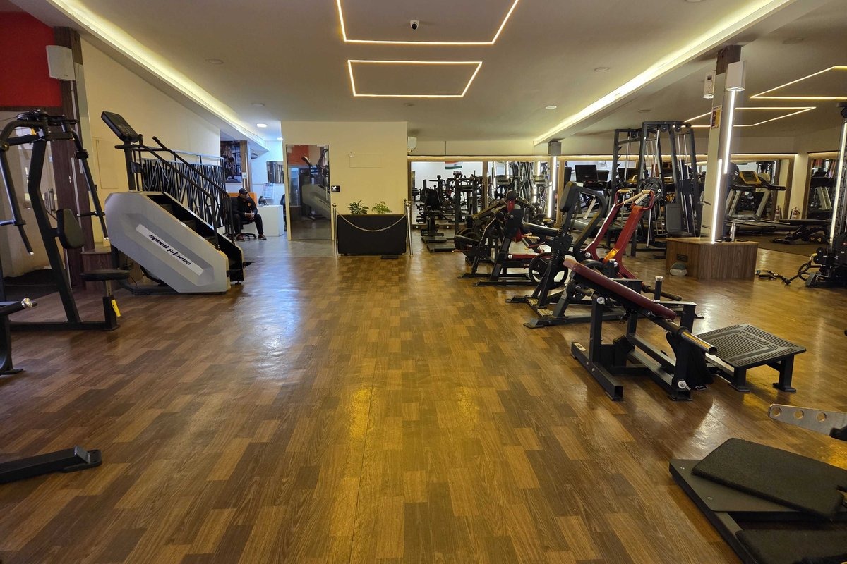 Main Strength Training Floor with Hardwood Flooring and Motorized Stair Climber