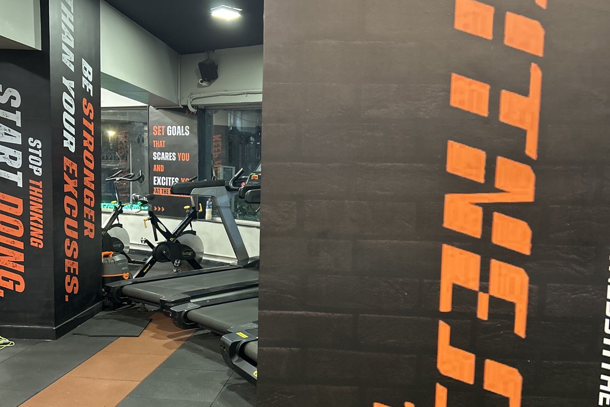 Branded Pillar with Fitness 11 Logo, QR Entry and Treadmills
