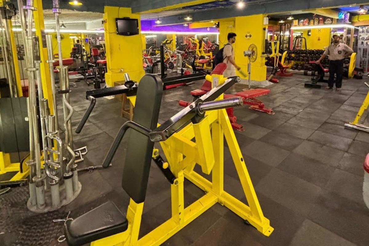 Plate-Loaded Chest Press Machine and Chrome Barbell Storage Tree
