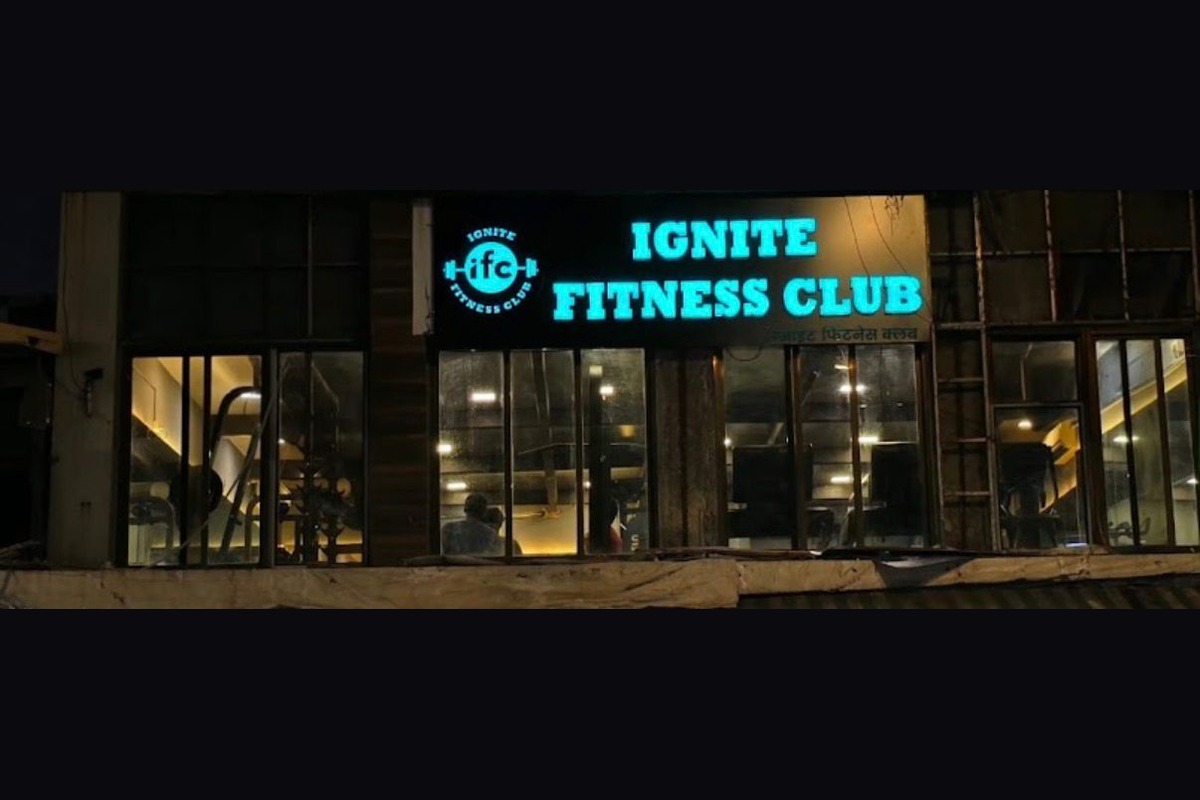 Illuminated Nighttime Facade with Cyan Neon Lightbox Signboard