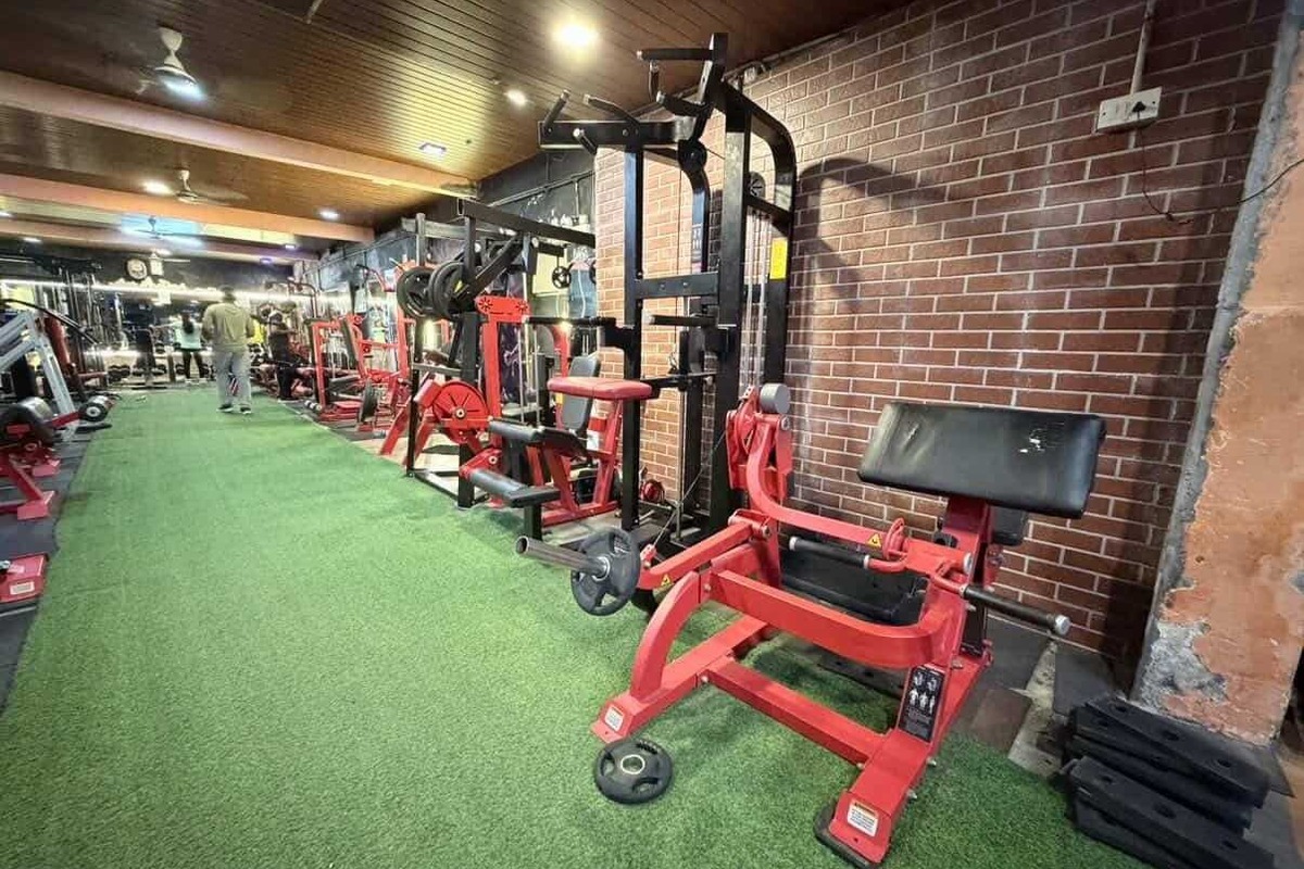 Commercial Preacher Curl Station, Assisted Dip Machine and Brick Accent Wall