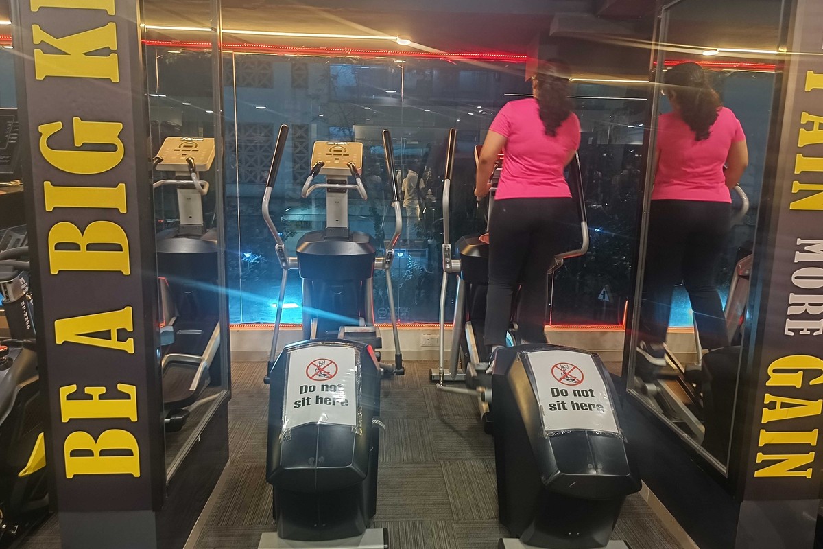 Cardio Deck with Commercial Ellipticals Against Glass Windows