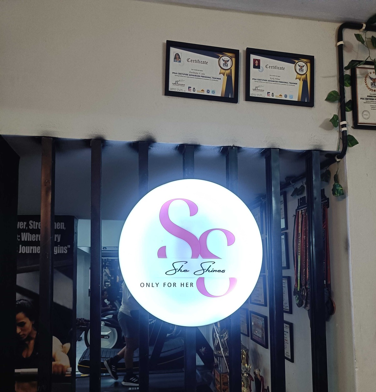 She shines Fitness Illuminated Logo, Certified Trainer Awards & Front Lounge