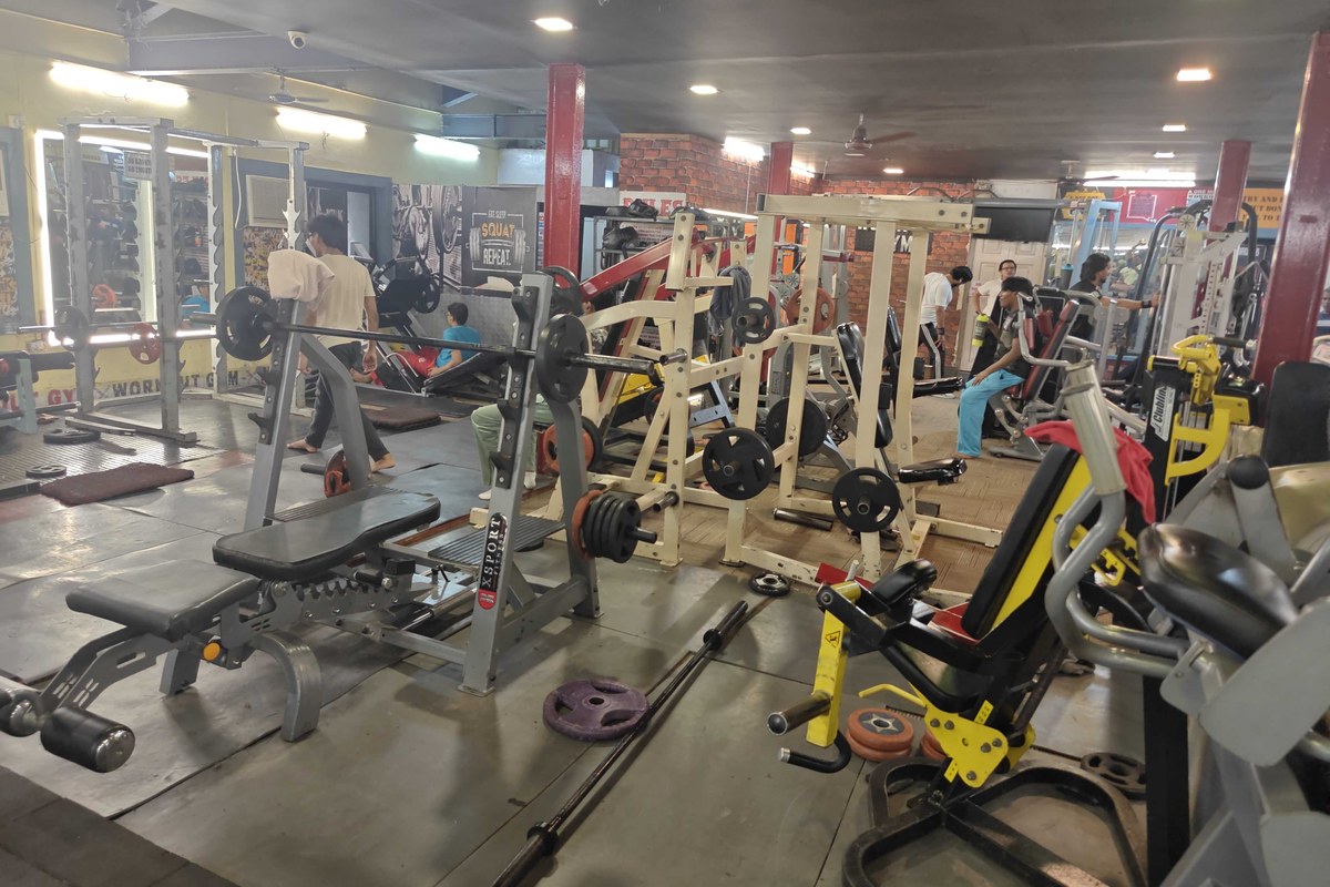 Olympic Flat Bench Press and Barbells on Rubber Floor